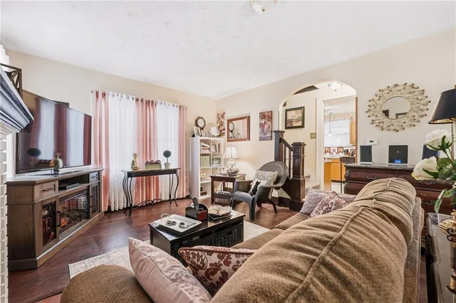 a living room with furniture fireplace and flat screen tv
