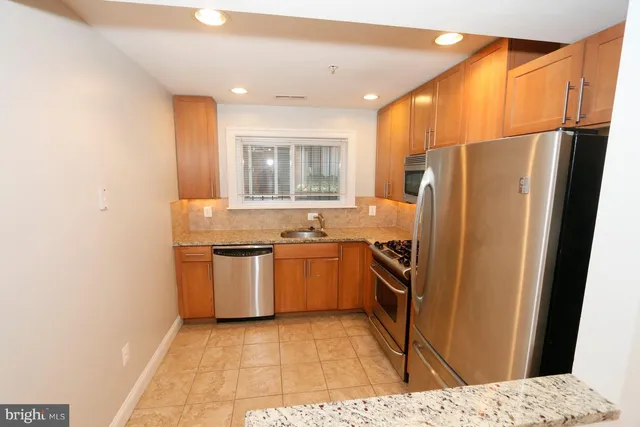 a kitchen with a refrigerator and a sink