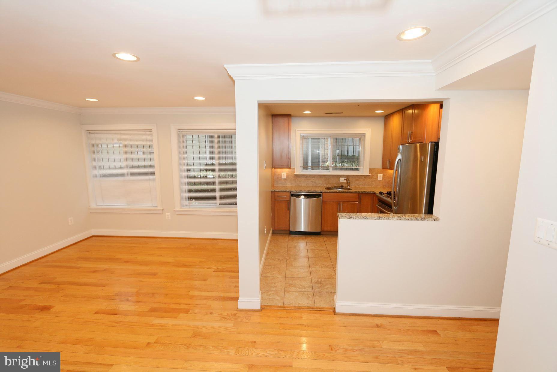 1901 Lincoln Road Northeast, Unit 101 Washington, DC 20002 - Photo 4 of 17 a view of a living room kitchen with a sink and a large window