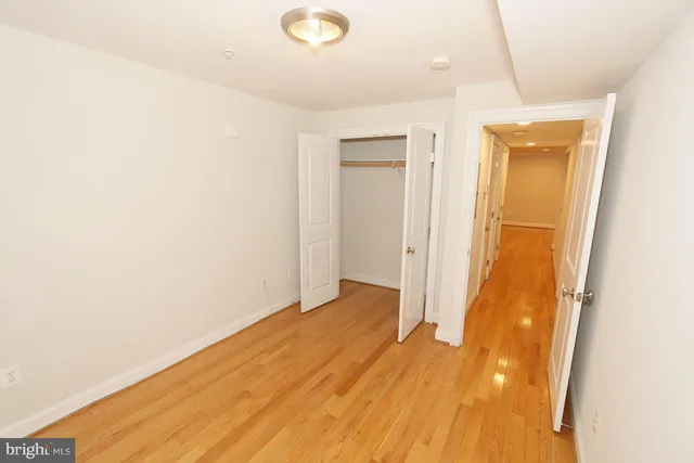 a view of a room with wooden floor