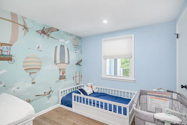 a bedroom with furniture and a window