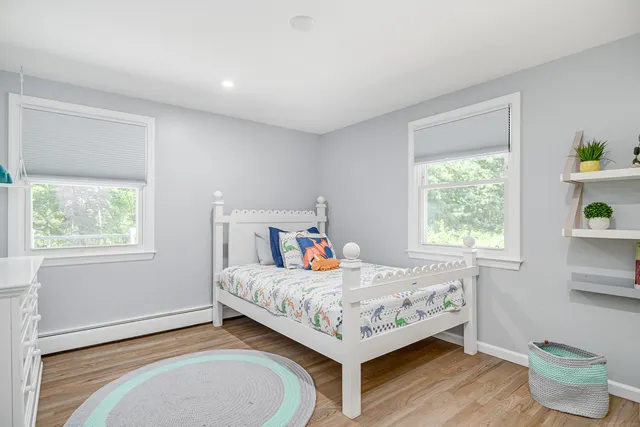 a bedroom with a bed and window