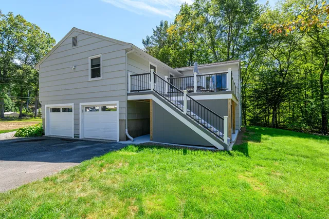 a front view of house with yard and green space