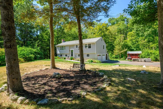 a view of a house with backyard and sitting area