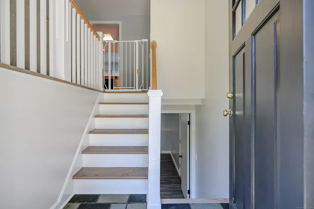 a view of staircase with white walls and windows