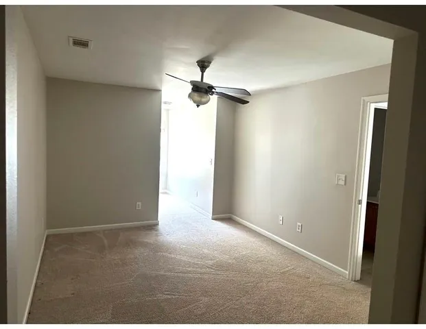 a view of a chandelier fan in a empty room