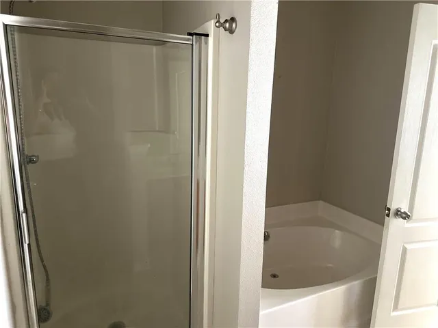 a bathroom with a shower and a bath tub
