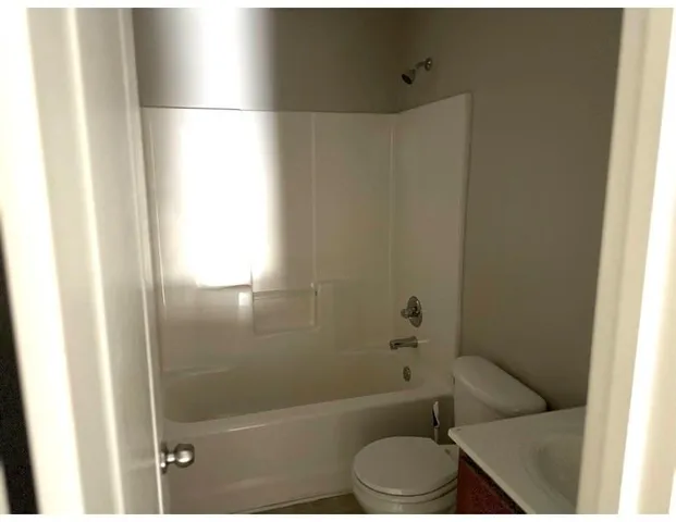 a bathroom with a toilet and a shower