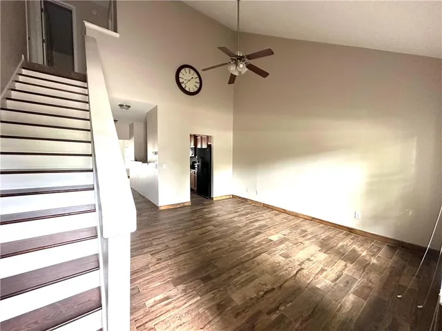a view of a room with wooden floor and white walls