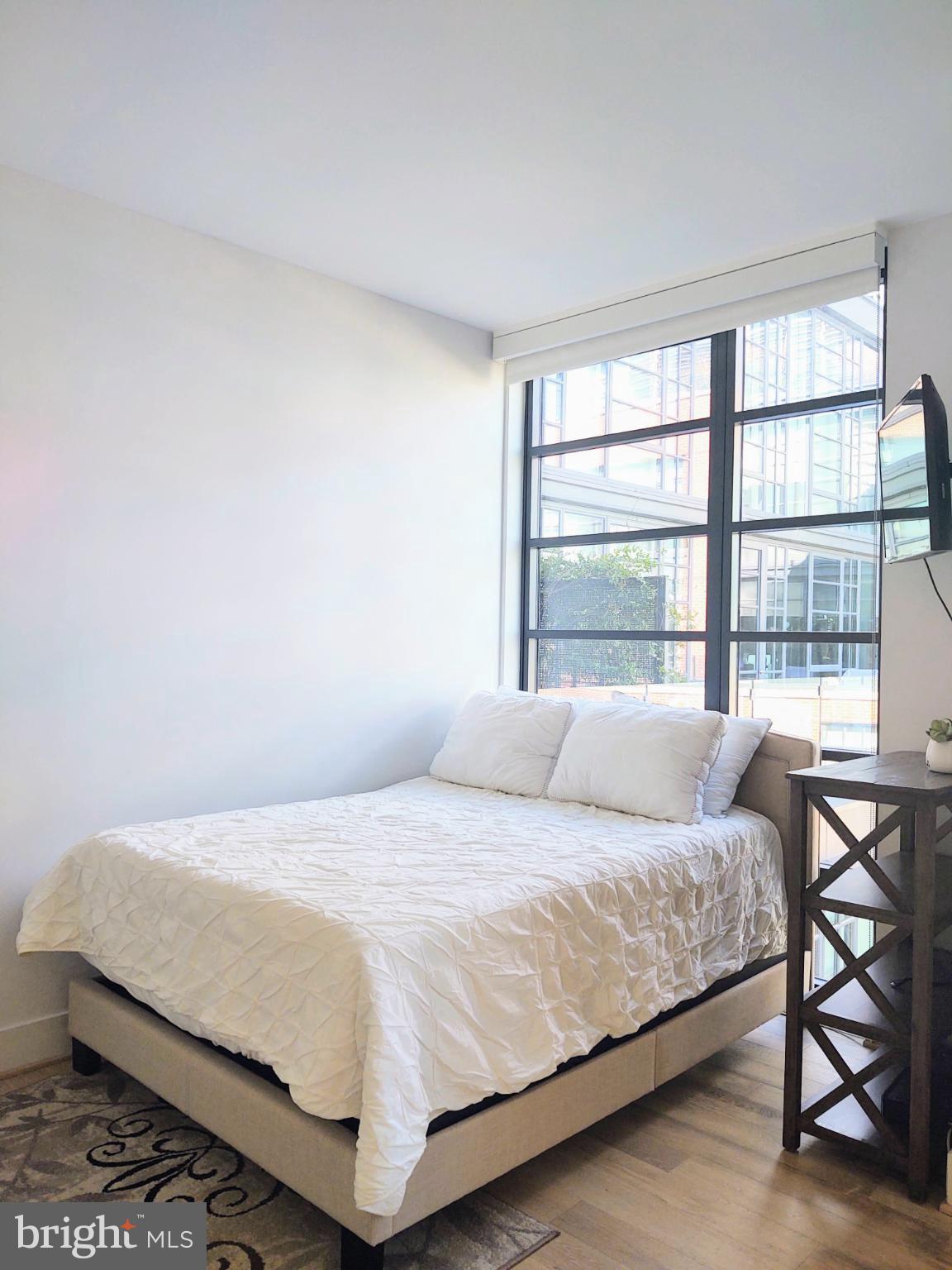 45 Sutton Square Southwest, Unit 1112 Washington, DC 20024 - Photo 11 of 46 Bright and airy bedroom space with modern charm.