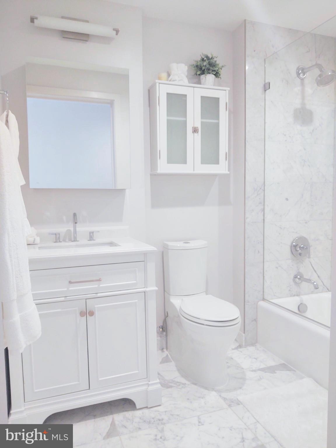45 Sutton Square Southwest, Unit 1112 Washington, DC 20024 - Photo 18 of 46 Sleek marble bathroom with elegant finishes.