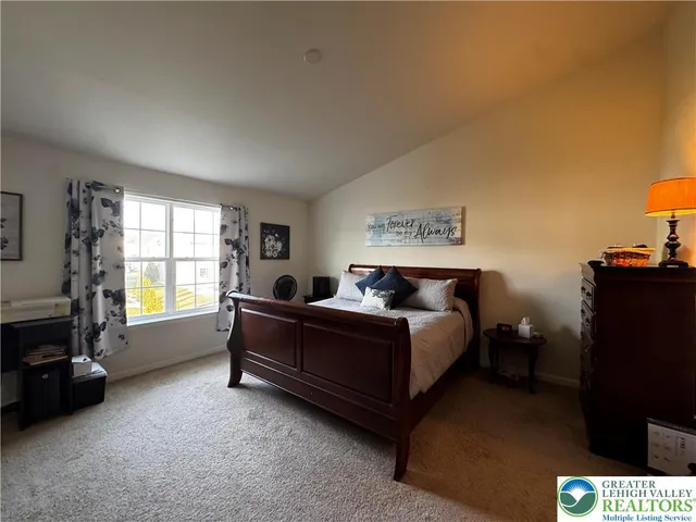 a spacious bedroom with a bed and a couch