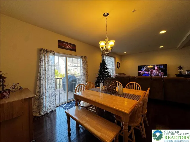a view of a dining room with furniture and chandelier