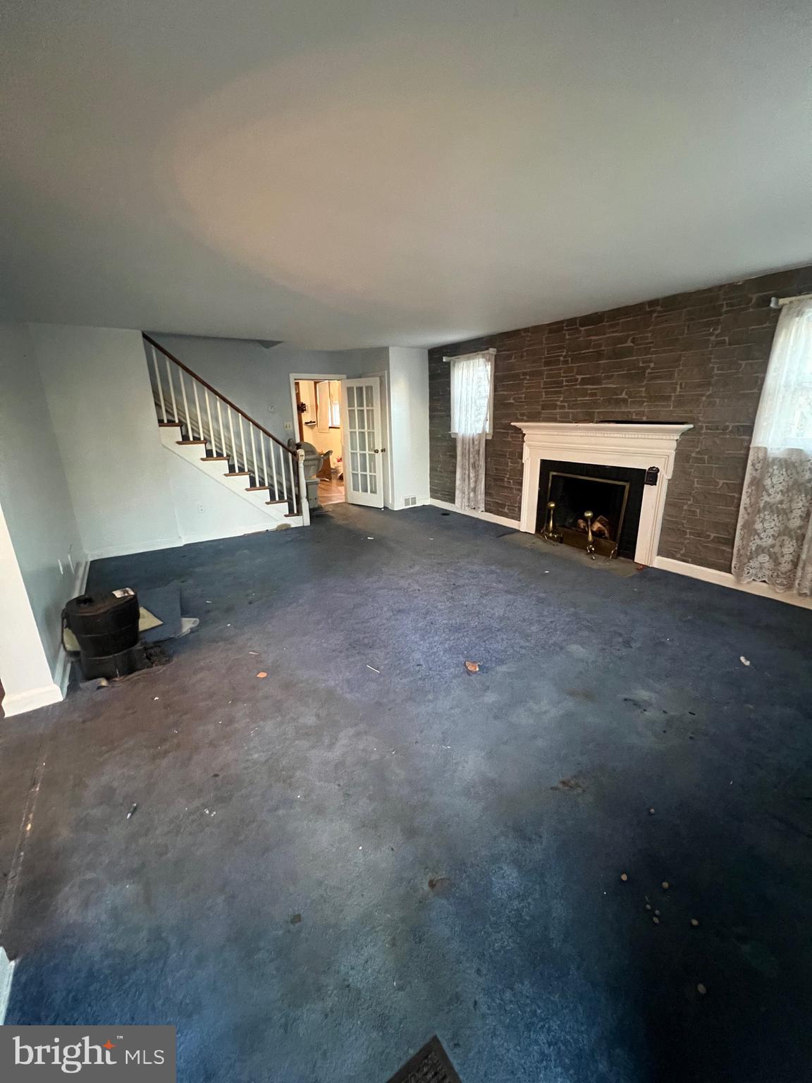 29 Beekman Road Wilmington, DE 19809 - Photo 7 of 32 a view of an empty room with a fireplace and a window