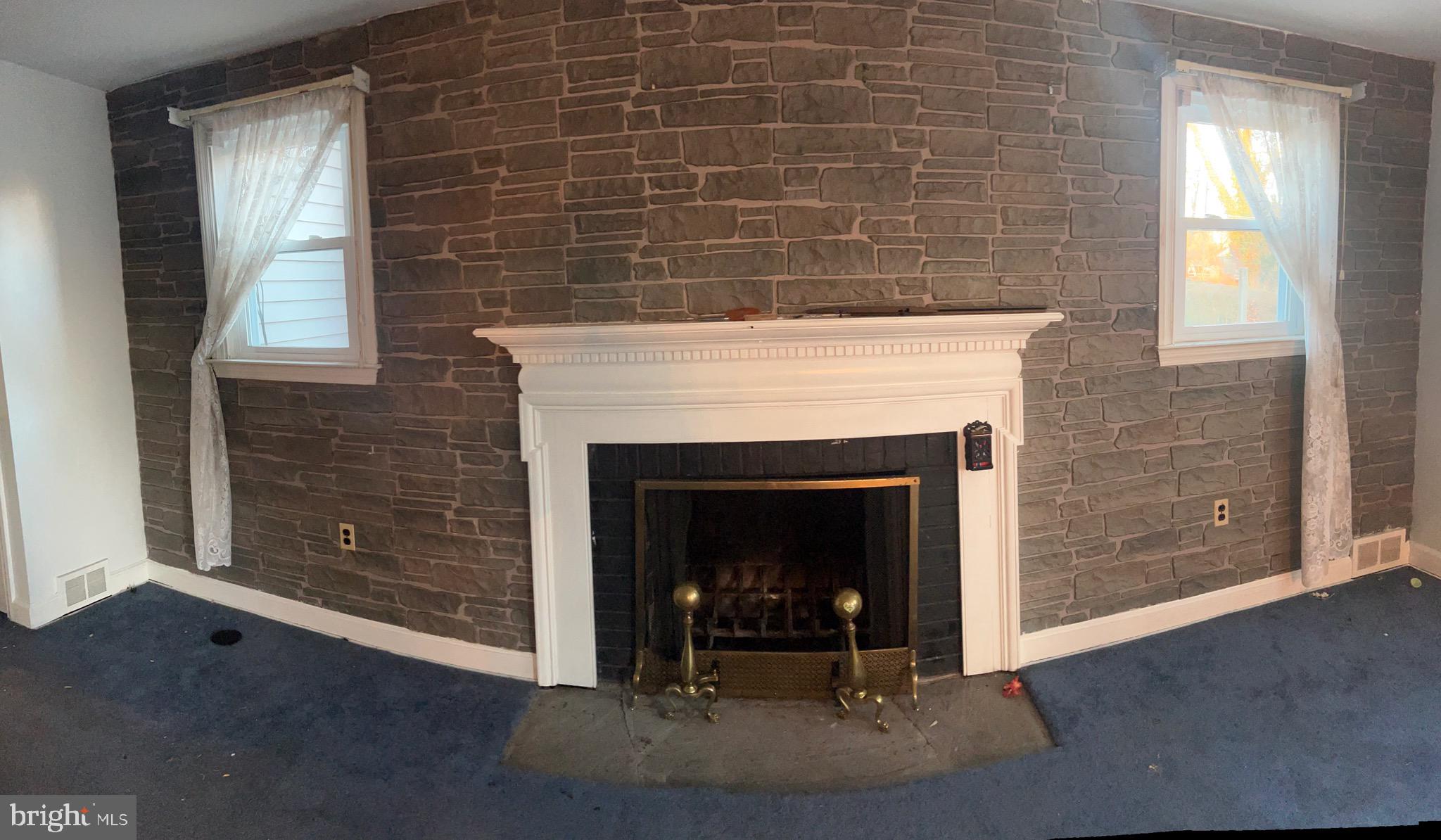 29 Beekman Road Wilmington, DE 19809 - Photo 8 of 32 a living room with a fireplace