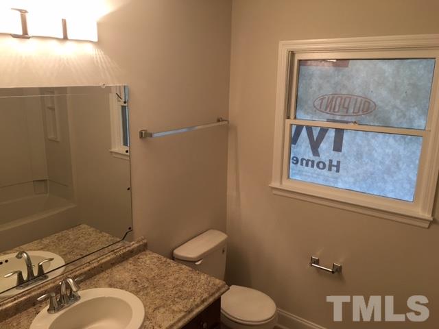 2324 Merganzer Road Raleigh, NC 27616 - Photo 8 of 9 a bathroom with a granite countertop sink toilet and a shower