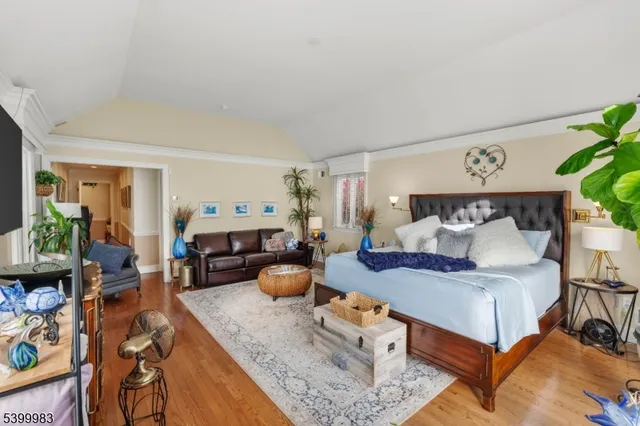 a bedroom with furniture and a wooden floor