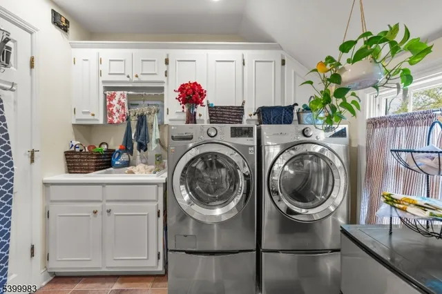 a kitchen with a refrigerator and white cabinets