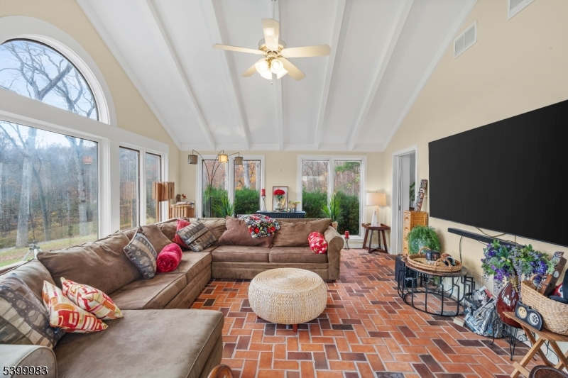300 Old Farm Road Bedminster, NJ 07921 - Photo 24 of 38 a living room with furniture a chandelier and a flat screen tv