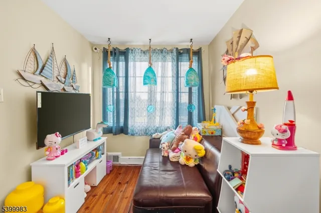 a living room filled with furniture and a flat screen tv