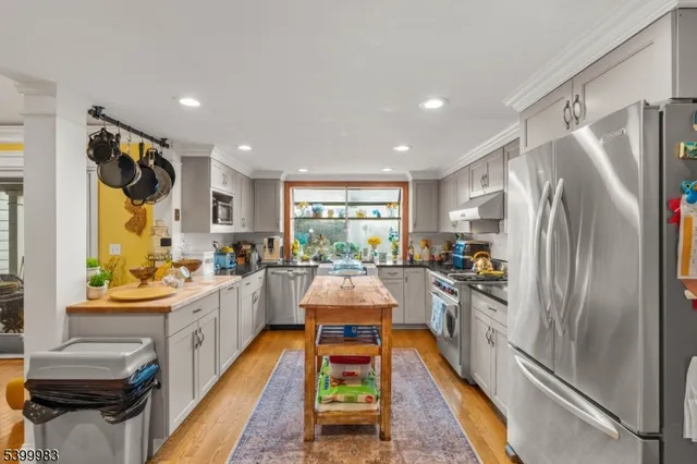 a kitchen with sink a refrigerator and a stove