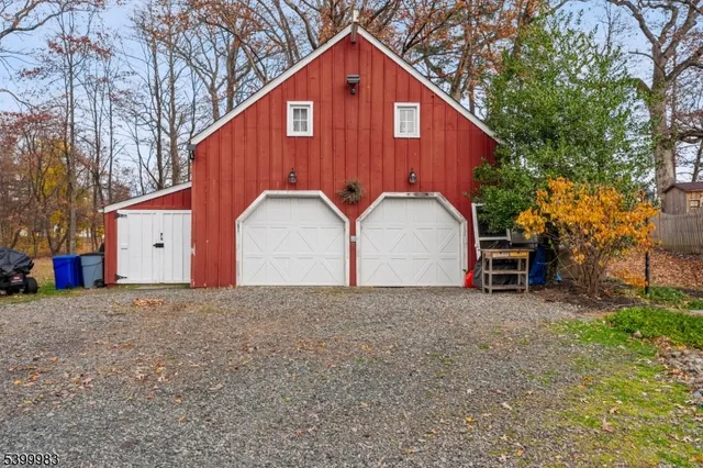 a view of a house with a yard and large tree