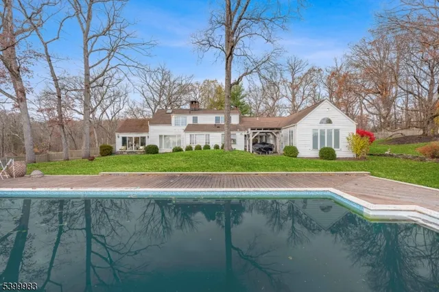 a view of yard with swimming pool and green space