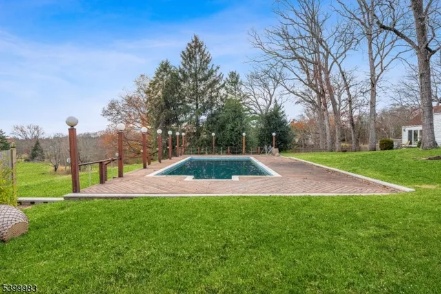 a view of yard with swimming pool and green space