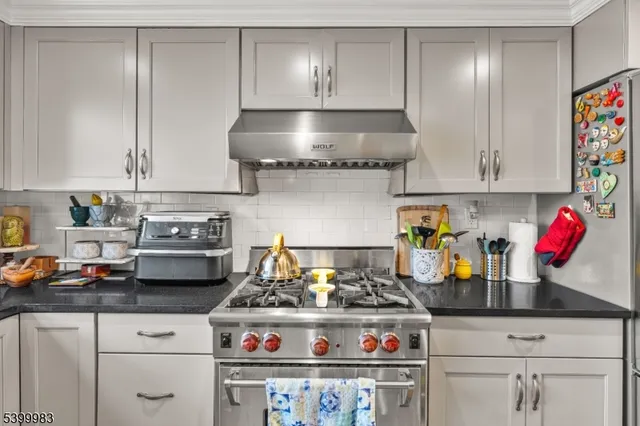 a stove top oven sitting inside of a kitchen