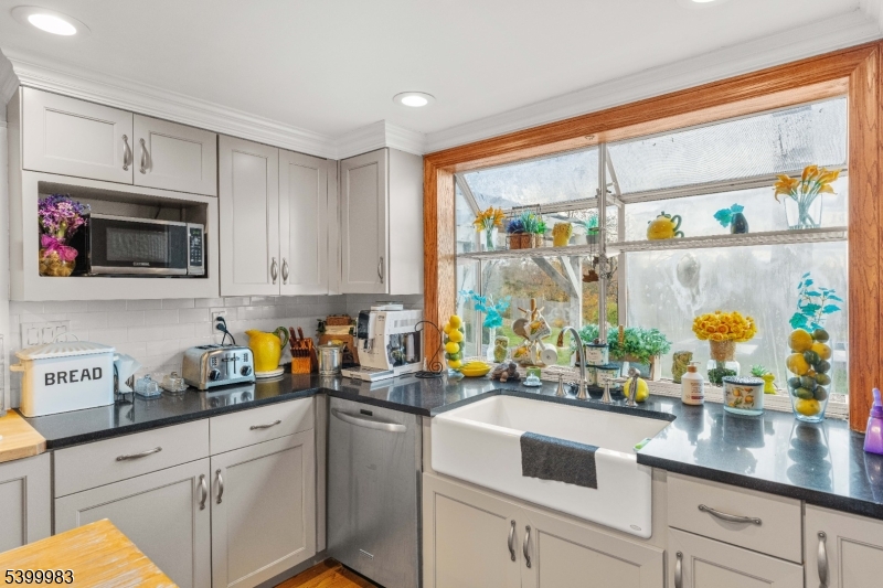 300 Old Farm Road Bedminster, NJ 07921 - Photo 6 of 38 a kitchen with stainless steel appliances kitchen island granite countertop white cabinets and a window