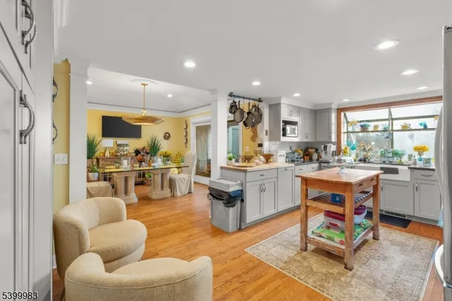 a living room with kitchen furniture kitchen view and a large window