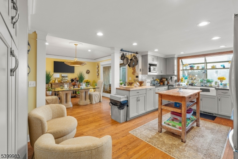300 Old Farm Road Bedminster, NJ 07921 - Photo 7 of 38 a living room with kitchen furniture kitchen view and a large window