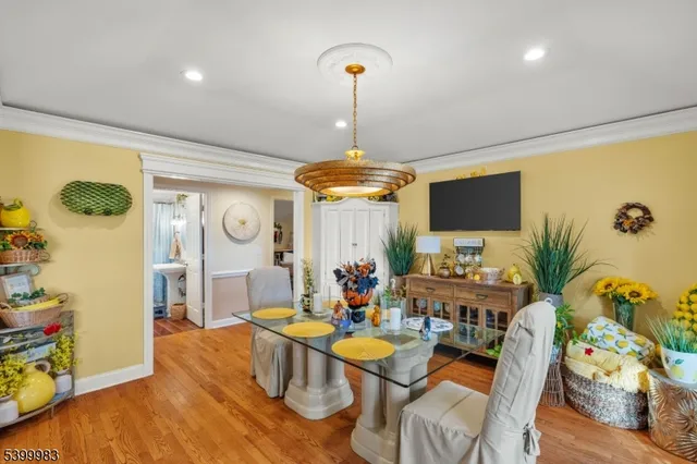 a living room with furniture a chandelier and a flat screen tv