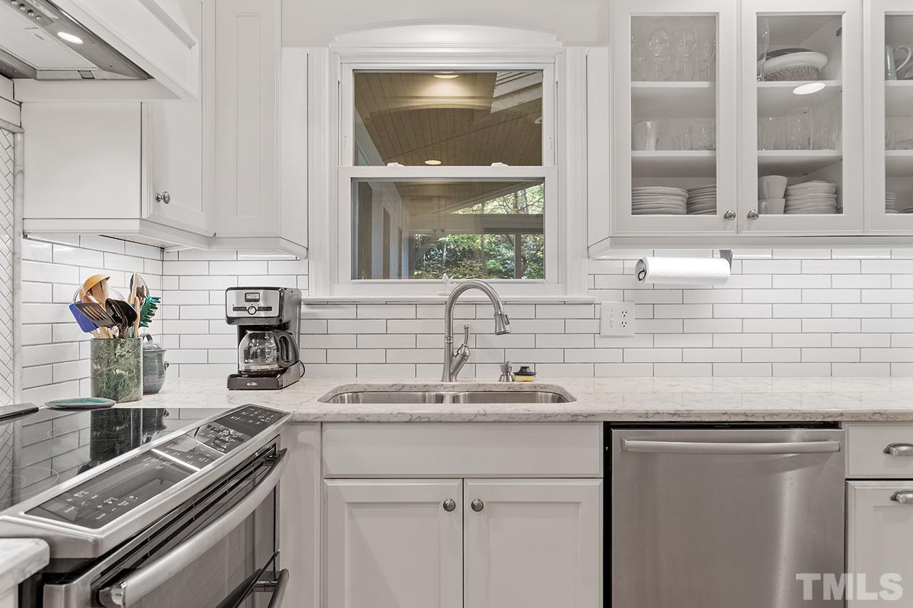 2408 Wentworth Street Raleigh, NC 27612 - Photo 16 of 33 a kitchen with a sink and cabinets