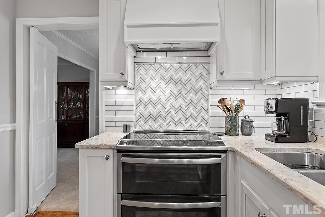 2408 Wentworth Street Raleigh, NC 27612 - Photo 17 of 33 a kitchen with granite countertop a stove and a sink