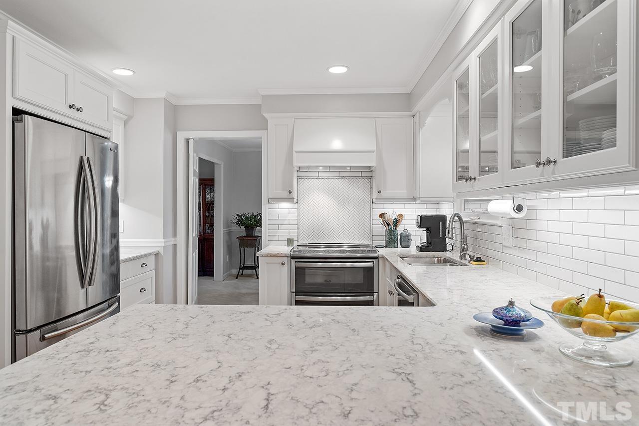 2408 Wentworth Street Raleigh, NC 27612 - Photo 19 of 33 a kitchen with stainless steel appliances granite countertop a refrigerator and a sink