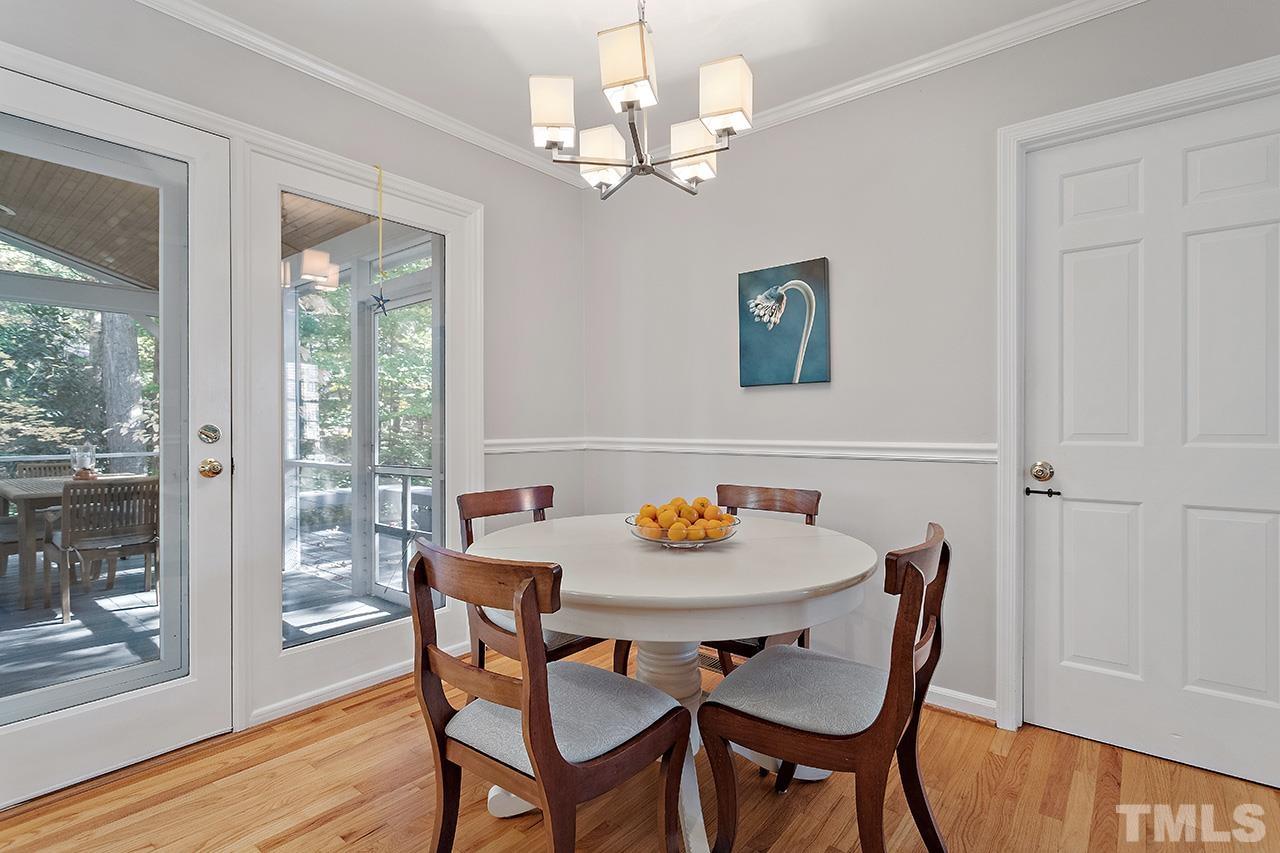 2408 Wentworth Street Raleigh, NC 27612 - Photo 20 of 33 a view of a dining room with furniture wooden floor and a chandelier