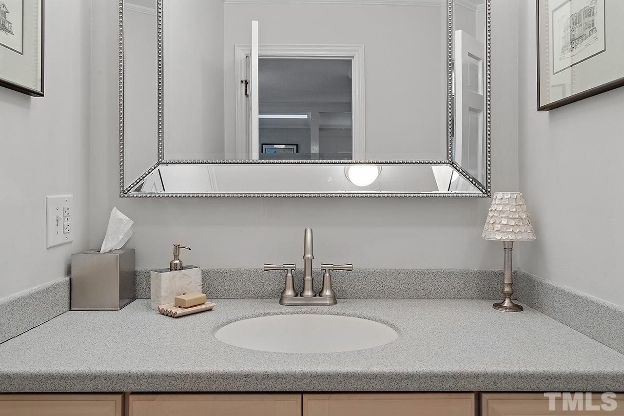 2408 Wentworth Street Raleigh, NC 27612 - Photo 21 of 33 a bathroom with a sink and a mirror