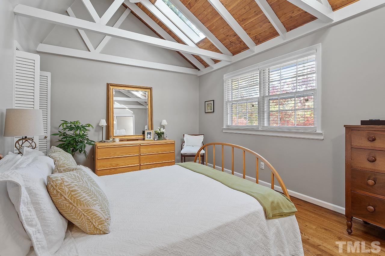 2408 Wentworth Street Raleigh, NC 27612 - Photo 22 of 33 a bedroom with two beds and potted plant