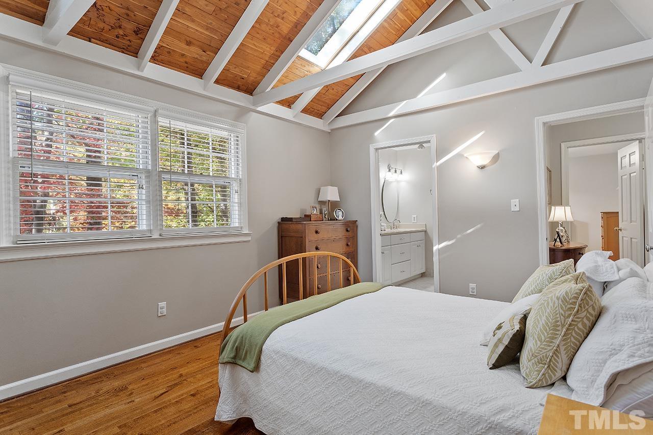 2408 Wentworth Street Raleigh, NC 27612 - Photo 24 of 33 a bedroom with a bed and wooden floor
