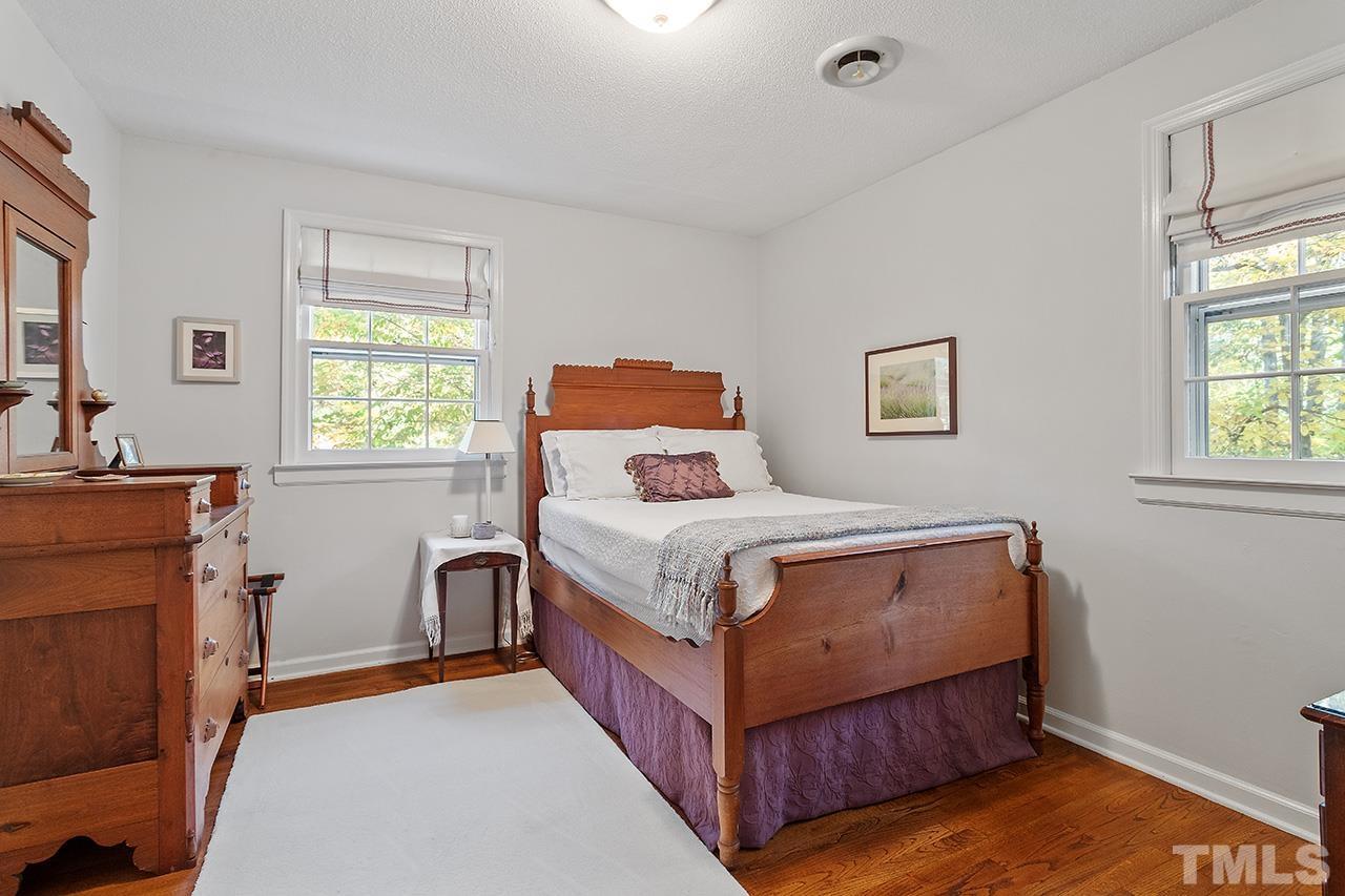 2408 Wentworth Street Raleigh, NC 27612 - Photo 27 of 33 a bedroom with a bed and windows