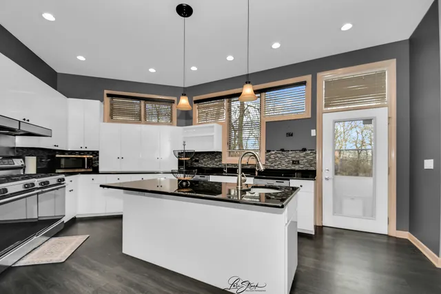 a kitchen with stainless steel appliances a sink stove and refrigerator