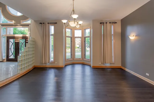 a kitchen with stainless steel appliances a stove a sink a oven a dining table and chairs