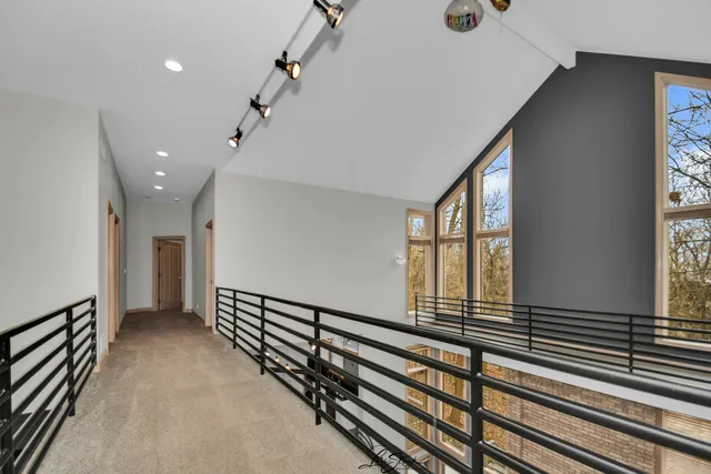 a view of an entryway with a flower pot and wooden floor