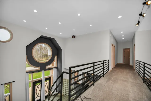 a spacious bedroom with a bed and a painting on the wall