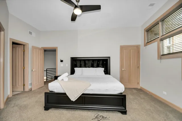 a bedroom with a bed and a closet with mirror