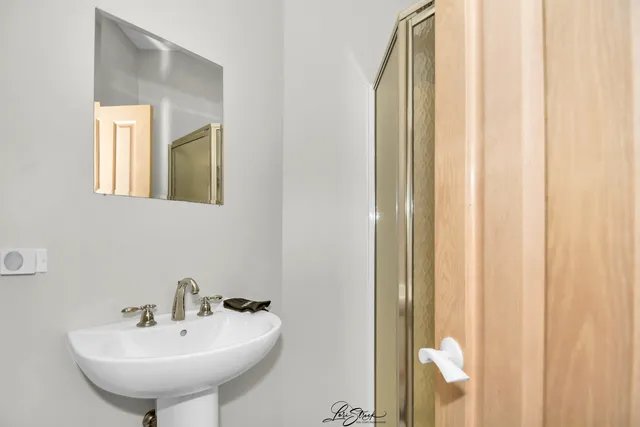 a bedroom with a bed and a night stand