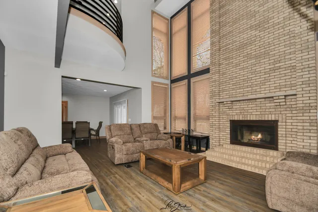 a view of a big room with wooden floor and windows