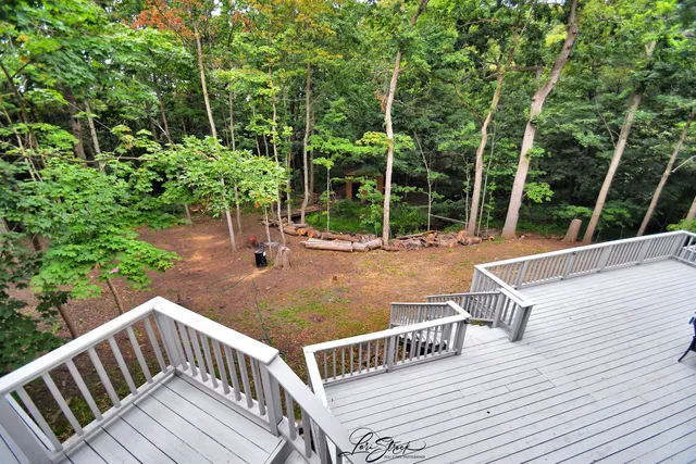 a backyard of a house with a yard and outdoor seating