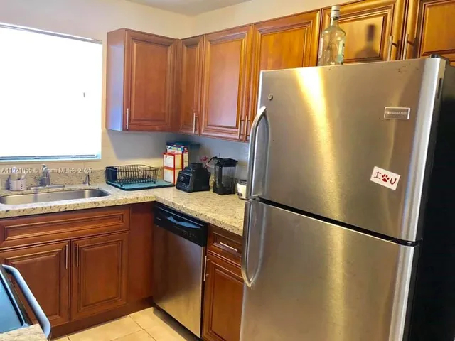 a white refrigerator freezer sitting in a kitchen